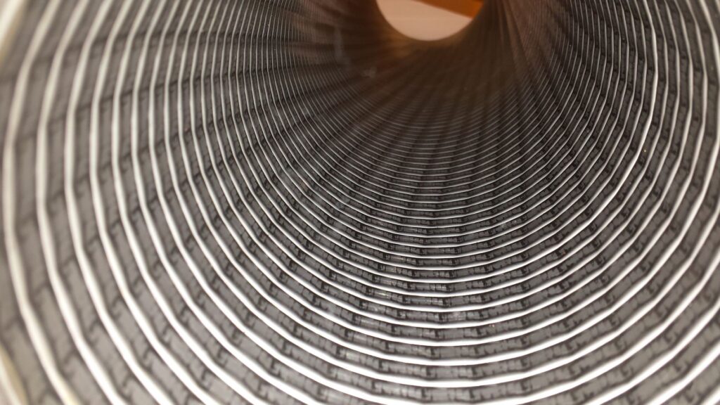 Image illustrating grain handling hoses in action, transferring grains from fields to storage facilities.